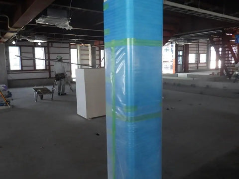 Blue protective covering wrapped around a pillar, showcasing wrapping application with green curing tape 50mm by 25m.