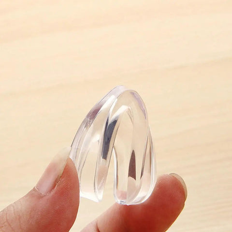 Safe Corner Protectors For Furniture With Double Sided Adhesive Tape 30 Pack PVC Corner Bumpers clear and held in hand