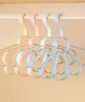Fan Shaped Closet Rod Organizer For Ties Scarves And Hats Made From Sturdy Polypropylene hanging on a rod in pastel colors.