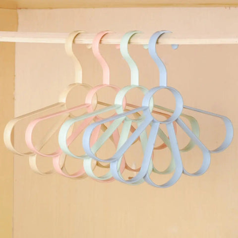 Fan Shaped Closet Rod Organizer For Ties Scarves And Hats Made From Sturdy Polypropylene hanging on a rod in pastel colors.