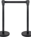 Front view of four piece pro grade crowd control stanchion set with 6.6 ft retractable belt black barrier with concrete and metal base.