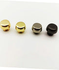 Bag feet rivets for handbags; four suitcase-style caps in gold-tone, silver, and black finishes (front view)