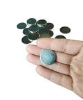 Slick Nickel Coated Steel Discs.98 Inch Diameter with smooth chamfered edges held in hand, surrounded by more discs.