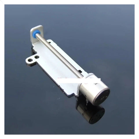 2 Phase 4 Wire Stepper Motor Operating As An 8Mm Travel Linear Slide Actuator with 33Mm metal housing on reflective surface.