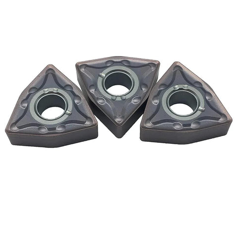 Three triangular WNMG432 carbide turning inserts with central bore for lathe tool holder; bronze finish.