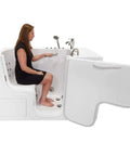 Sleek 32X52 Acrylic Transfer Walk In Tub With Heavy Duty Hydro Massage And Microbubble Jets, side view with user seated.