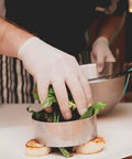 Top Notch Latex Disposable Gloves With Corn Starch Powdered Finish For Food Handling And Light Industrial Chores Smooth As Butter X Large Bulk Case Of 1000 in use by chef.