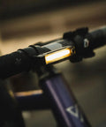 Dope Front Bike Light With USB Rechargeable Battery mounted on bike handlebar, displaying bright COB LED for night rides.