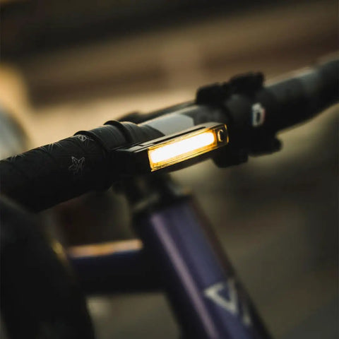 Dope Front Bike Light With USB Rechargeable Battery mounted on bike handlebar, displaying bright COB LED for night rides.