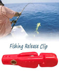 Red plastic fishing release clip for planer boards on offshore trolling boats.