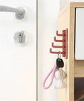 Slick Rotary Sticky Hook Wall Mount With Heavy Duty Adhesive Grip For Keys And Coats No Drill Hassle attached to a cabinet.