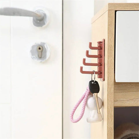 Slick Rotary Sticky Hook Wall Mount With Heavy Duty Adhesive Grip For Keys And Coats No Drill Hassle attached to a cabinet.