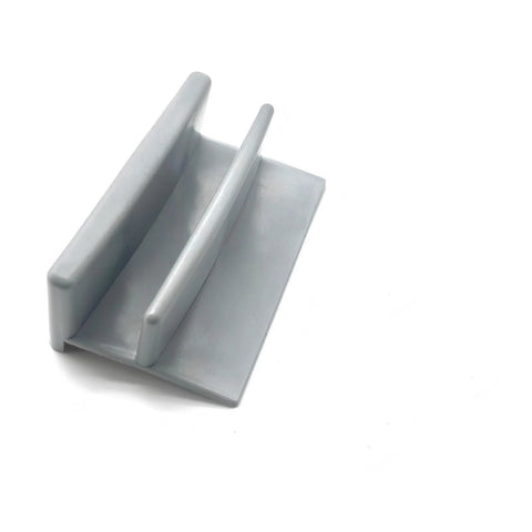 Side view of a single gray plastic shower door guide part of the 5 Pack Gray Plastic Sliding Shower Door Bottom Guides M6192 For Sliding Shower Doors With Half Inch Channel, Includes Fasteners, Delivers Precise Alignment, Centered Tracks, And Smooth, Consistent Movement.