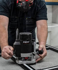 Worker using Adjustable Router Jig Frame and Guide System for Cutting Square and Rectangular Recesses, Slots, and Face Panel Molds