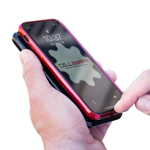 Universal Dual Phone Carrier With Strong Magnetic Mounts For Smart Device Storage, holding two smartphones in hand.