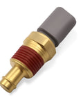 Engine coolant temperature sensor with brass threaded body, red sealant, and gray plastic connector — close-up view