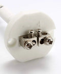 Close-up of white ceramic K-type thermocouple block with two metal terminal clamps and screws