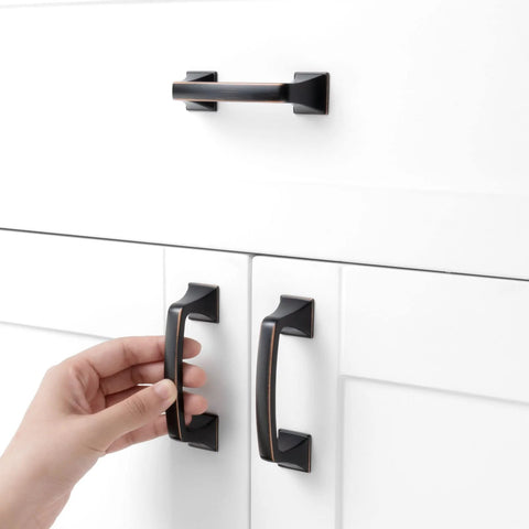 Hand reaching for 10 Pack 3 Inch Oil Rubbed Bronze Drawer Pulls Brushed Bronze Cabinet Handles for Cabinets and Drawers Ideal for Kitchen Bedroom Dresser