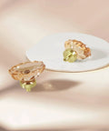 Four Pack Glass Cabinet Knobs And Pulls With Oval Champagne Crystal Knobs On Satin Brass Brushed Gold Base For Dresser Wardrobe And Cabinet Drawers Easy Install With Three Screw Options shown on a white plate.