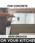 Applying Heavy Duty Water Based Concrete Countertop Sealer With Slick Matte Finish And Food Safe Shield on a kitchen counter.