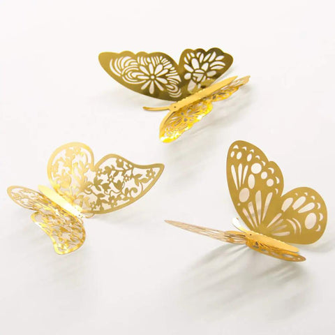 Three gold 3D butterflies from 3D Butterfly Wall Decor Set Featuring Gold, Rose Gold And Silver Butterflies Perfect For Cake Decorating, Party And Wedding Decor Includes 72 Pieces With Double Sided Adhesive Dots For Quick, Standout Accents.