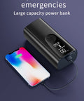 Portable power bank charging smartphone with digital display showing battery percentage.
