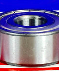 Side view of 5304ZZ Angular Contact Bearing 20x52x22.2mm in chrome steel, double-row design with metal shields, against a striped background.