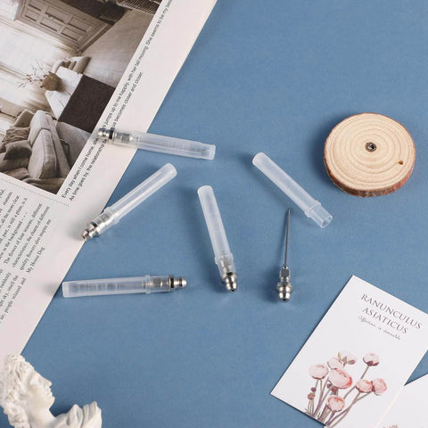 5pcs Grease Injector Needle set on a blue surface, showing small bearing grease needle nozzles and detachable tips for ball joints.