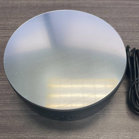 6" Electric Rotating Display Stand - Mirror Turntable USB/Battery with glossy surface and power cable.