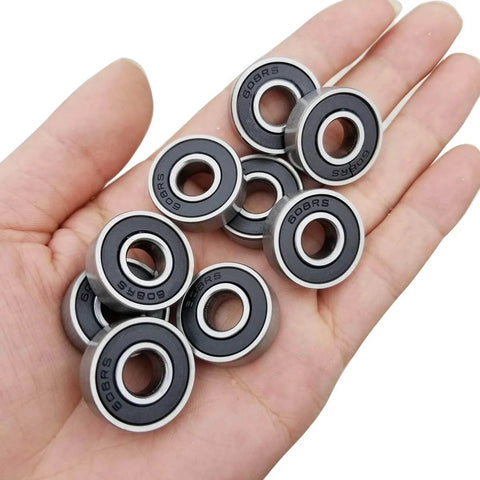 Hand holding 100 PCS 608-2RS Ball Bearing - Double Rubber Sealed Shielded Miniature Deep Groove Bearings for Small Machinery and More
