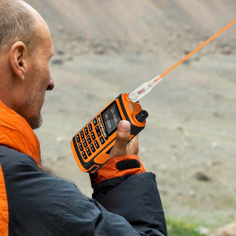 Person using Dual Band Walkie Talkie Antenna For 144 And 430 MHz With SMA Female Connector in outdoor setting