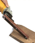 Upgrade Your Angle Grinder With This Solid Belt Sander Converter For Woodworking, shown in use on wood for DIY sanding.