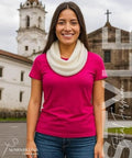 Woman wearing Ultra Cozy Winter Cashmere Infinity Scarf in Beige, standing outdoors with church background