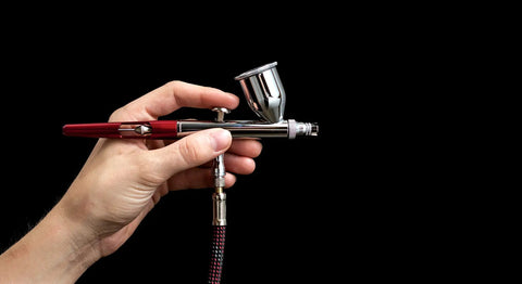 VFan Gravity Feed Dual Action Airbrush System Portable Pro Grade Dope Tool in hand against black background