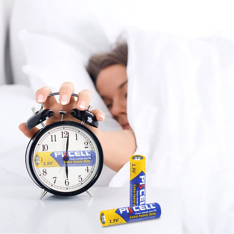 Person reaching for alarm clock powered by 100 Pack AAA Batteries Carbon Zinc R03P 1.5V Single Use Triple A Power Pack
