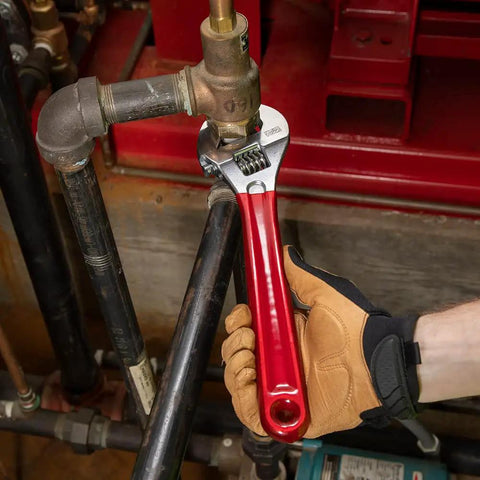 Adjustable Drive Wrench With Extra Capacity Jaw used on a pipe, 12-Inch forged alloy steel with high polish chrome finish, red handle