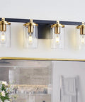 4 Light Modern Vanity Light Fixtures For Bathroom In Matte Black And Brushed Gold With Clear Glass Shades Over Mirror
