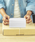 Stack of 100 Pack White EPE Foam Packing Pouches For Electronics And Fragile Items on a cardboard box