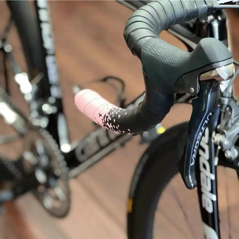 Black bike handlebar with brake levers, featuring Shimano hood covers. Silicone Hood Covers For Bike Brake Levers And Shifters.