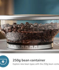 Top Shelf Semi Automatic Espresso Machine With Integrated Grinder And Dual Wall Baskets For Fresh Single Double Shots Plus Americano Brewing In Sleek Metal Silver With Calibrated Tamping Tool 250g bean container filled with coffee beans.