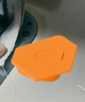 Magnetic Seam Guide For Sewing, orange tool on sewing machine, secure magnet attachment for precise hem alignment on fabric