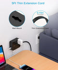 Slick Flat Power Strip Surge Protector With Eight Wide Outlets And Four Fast Charge Usb Ports For Gaming Rig Home Office Boss Level Protection Heavy Duty Five Foot Extension Cord mounted beside a couch, showing thin extension cord and wall mount.