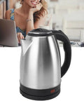 Fast As Lightning 2 Liter Electric Kettle With 1500 Watt Kickin Boiling Power Auto Shut Off And Dry Boil Protection Stainless steel kettle with black handle on kitchen counter.