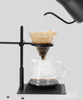 Adjustable Pour Over Coffee Stand Featuring Rock Solid Aluminum Base For Home Office Brewing with a drip coffee setup in use.
