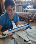 Boy holding airplane from City Airport Building Block Set For Kids Aged 6 To 12 With 463 Pieces Plane Station And Helicopter Build Kit