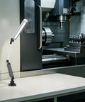 Heavy Duty 110V 16W LED Machine Work Light Featuring An Innovative 180 Degree Adjustable Bracket on machining table in workshop.