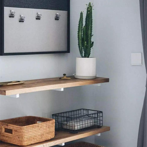 Legit White Shelf Brackets And T Shape Wall Mounts Solid Iron Floating Shelf Hardware supports a wooden shelf with a cactus.