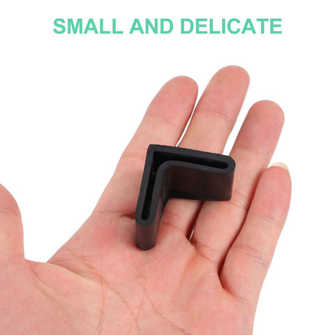 L Shape Black Rubber Furniture Leg Caps Set For Tables And Shelves Floor Protectors in hand, showing small size and L shape.