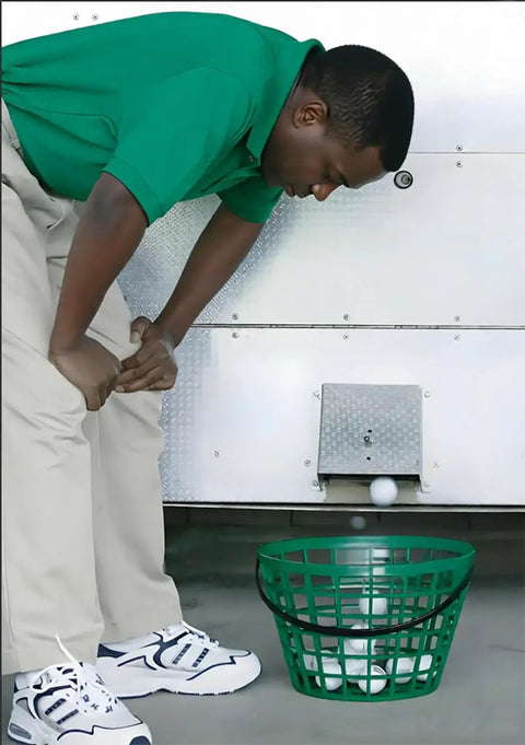 Green Golf Ball Basket With Handle, Holds Up To 50 Balls, positioned beneath ball dispenser, used for outdoor practice