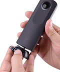 Hand attaching camera to Quick Release Flat And Curved Surface Camera Mount With Strong Adhesive Base for secure use.